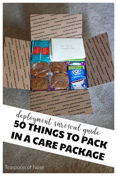 an open box filled with cookies and snacks on top of a carpeted floor next to a