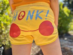 Clown shorts that say HONK on the butt. Clown face on the front is embroidered, design on the back is screenprinted.  Made out of a very soft, cuddly and stretchy fleece blend (90% cotton / 10% polyester).  Please refer to size chart to find your size. Shorts have an elastic waist and some stretch. Modeled shorts are size medium; final product image is a size medium and a size 3XL. Has pockets! Clown Shorts Pattern, Clowncore Aesthetic Outfits, Clowncore Pants, Clown Inspired Outfit, Casual Clowncore, Clown Core Fashion, Yellow Clown Aesthetic, Clown Core Outfit, Kidcore Clowncore Outfits