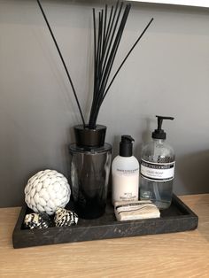 a black tray with soap, toothbrushes and other bathroom items on top of it