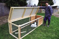 a man standing next to a chicken coop