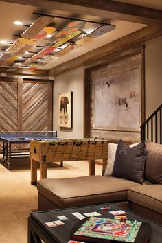 a living room filled with furniture and a ping pong table