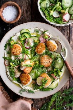 a white plate topped with shrimp and cucumber salad