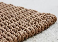 a close up view of a woven cloth on the floor with white speckles