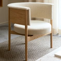 a wooden chair sitting on top of a carpeted floor