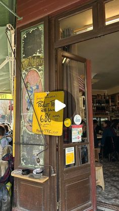 people are standing in front of a store with signs on the doors that say don't enter