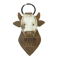 a cow keychain with a leather tag attached to it