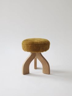 a small stool made out of wood with a yellow cushion