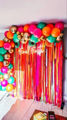 a room filled with lots of balloons and streamers