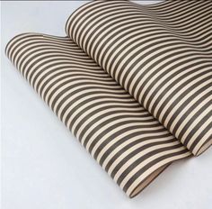 two black and white striped pillows laying on top of each other