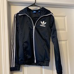 Nwot Adidas Shiny Navy, Has A Sheen That Feels So Nice White Stripes Down Sleeves Elasticized Waist Band Full Zip 2 Zipped Pockets In Front Size Small Adidas Long Sleeve Windbreaker For Fall, Casual Navy Track Jacket, Adidas Navy Long Sleeve Track Jacket, Navy Adidas Long Sleeve Track Jacket, Navy Long Sleeve Track Jacket For Spring, Adidas Fitted Hooded Outerwear, Adidas Fitted Long Sleeve Outerwear, Casual Navy Adidas Outerwear, Fitted Long Sleeve Adidas Outerwear