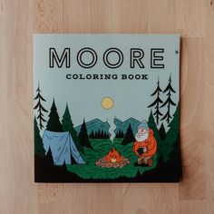 a coloring book with an image of a man sitting in front of a campfire