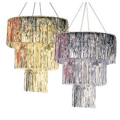 three chandeliers hanging from the ceiling with fringes on them, one is multicolored