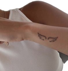 a woman with a small tattoo on her arm