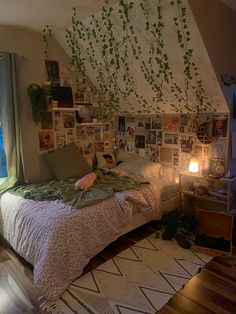 a bed sitting in a bedroom next to a window with pictures on the wall above it