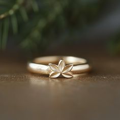 a gold ring with a flower on it