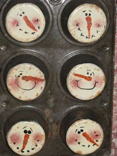 four cupcake tins with frosting decorated like carrots and snowman faces