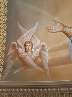 a painting on the ceiling of a building with two hands reaching out to an angel