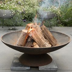 a fire pit sitting on top of a cement slab