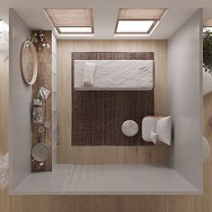 an overhead view of a bathroom with wood flooring and white towels on the bed