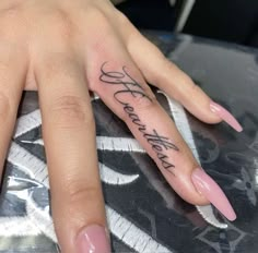 a woman's hand with a tattoo on it that says, love is all you need