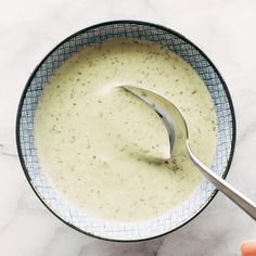 a spoon in a bowl filled with cream sauce