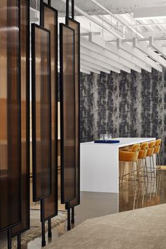 an empty room with chairs and dividers on the floor in front of a wall