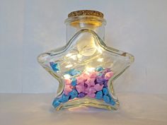 a glass bottle filled with pink and blue flowers