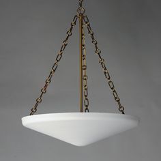 a chandelier hanging from a ceiling fixture with chains on the bottom and sides