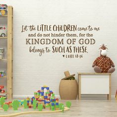 a child's playroom with toys and wall decal saying let the little children come to me and do not bind them, for the kingdom of god belongs to such as thee