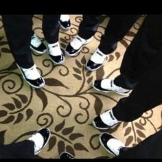 a group of people standing in a circle with their feet on each other's ankles