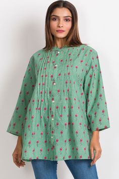 Our Amisha Cotton Tunic is a popular new addition to our sustainable apparel collection. Made with printed 100% cotton fabric, this fair trade tunic features a button down front and roll up button sleeves. These soft cotton tunic tops are free size, and are designed for an elegant, comfortable fit up to size XXL. One size fits most. Green Printed Blouse For Daywear, Green Floral Print Tunic Blouse, Cotton Tunic Blouse With Buttons, Green Tunic For Daywear, Casual Cotton Tunic Shirt, Green Long Sleeve Tunic With Printed Motifs, Spring Straight Kurta Blouse With Printed Motifs, Green Straight Kurta Blouse For Summer, Traditional Green Cotton Shirt