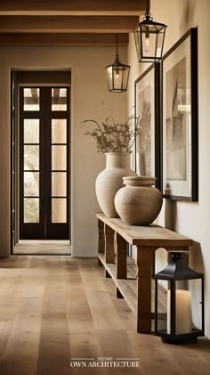 an entry way with vases and lanterns