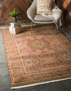 a large rug with an ornate design on the floor in front of a wooden wall