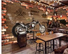 a motorcycle is mounted to the wall in a restaurant with wooden tables and stools