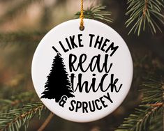 a christmas ornament hanging from a tree with the words like them real thick and spruce