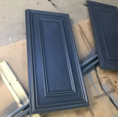 three blue cabinets sitting on top of a wooden floor