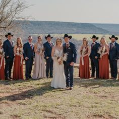 a large group of people standing in front of each other on a grass covered field