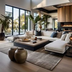 a modern living room with large windows and lots of furniture in the middle of it