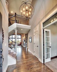 the inside of a house with an open floor plan and pictures on the front door