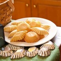 some cookies are sitting on a plate next to a basket and other items in front of it