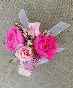 a bouquet of pink flowers on top of a table