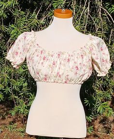 Embrace timeless charm with this handmade crop top, crafted from vintage Rose fabric.  This is a Crop Top, not a Midriff (longer). This Top measures 30-32 around the bust.  Each top is a one-of-a-kind piece, combining classic charm with modern style. Whether you're dressing up for a day out or adding a unique touch to your everyday look, this crop top is your perfect match. This top would pair perfectly with a pair of jeans & boots for a day at the farmers market.  This is truly One Of A Kind. I only found 2 yards of this fabric at an estate sale. Vintage Short Sleeve Crop Top For Spring, Vintage Fitted Tops For Garden Party, Vintage Short Sleeve Tops For Garden Party, Vintage Cropped Floral Print Top, Vintage Fitted Cropped Top, Fitted Cropped Vintage Crop Top, Fitted Vintage Cropped Crop Top, Fitted Vintage Cropped Top, Vintage Floral Print Crop Top For Spring