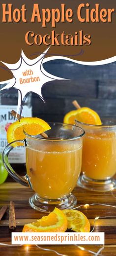 hot apple cider cocktails with bourbon on the side and an orange slice next to it