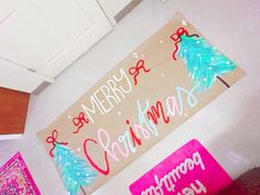 a merry christmas sign hanging from the side of a wall next to other holiday decorations