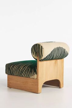 a zebra print chair with a green cushion