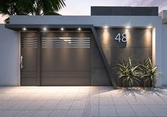 an entrance to a modern home with plants in the foreground and palm trees on the other side