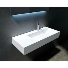 a white sink sitting under a bathroom mirror next to a wall mounted faucet