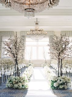 an image of a wedding venue with flowers on the aisle and trees in the middle