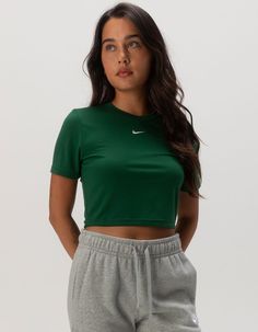 Nike Sportswear Essential Slim Crop Tee. Embroidered Nike Swoosh Logo On Center Chest. Ribbed Crew Neckline. Short Sleeve. Slim Fitting, Cropped Fit. 49% Polyester, 48% Modal, 3% Spandex. Machine Wash. Imported. Model Is Wearing A Size Small. Model Measurements:height: 5'7" Bust: 34"waist: 25"hips: 34.5" Sporty Workout T-shirt, Nike Cropped Short Sleeve T-shirt For Sports, Spring Gym T-shirt With Crew Neck, Basic Tops With Moisture-wicking And Medium Support, Basic Moisture-wicking Top With Medium Support, Basic Tops With Medium Support And Moisture-wicking, Basic Moisture-wicking Top, Spring Casual Cropped T-shirt For Sports, Green Spring Athleisure T-shirt