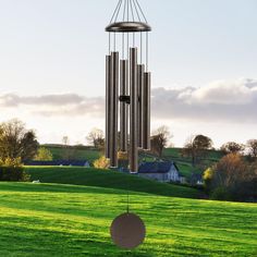 a wind chime in the middle of a green field